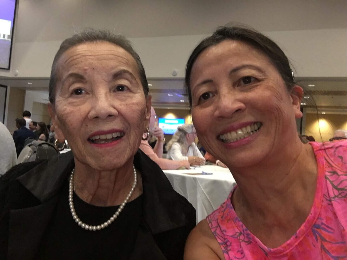 Two elderly women at a formal event