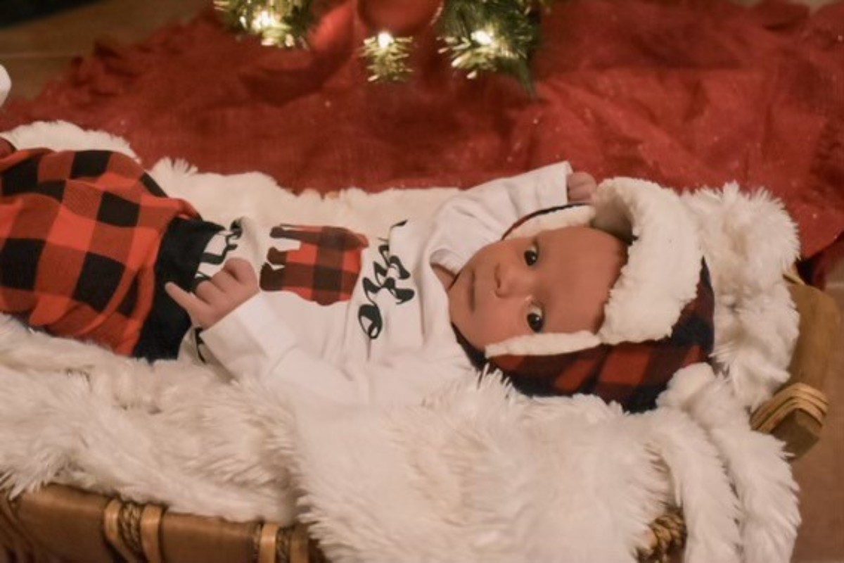 A baby wearing comfortable Christmas-themed clothes