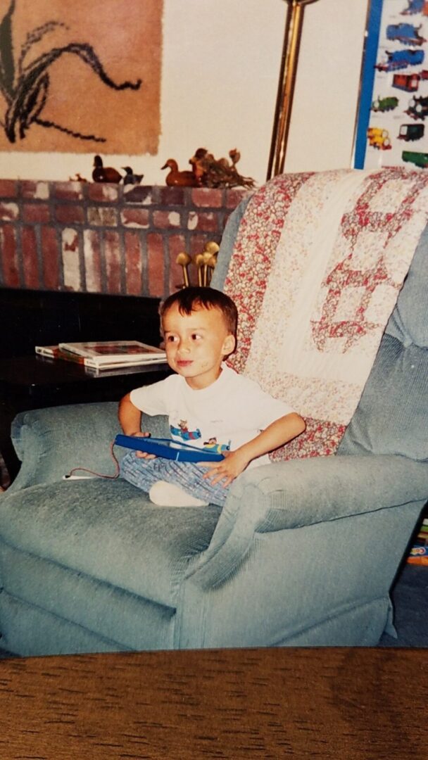 A child sitting on a large single-person couch